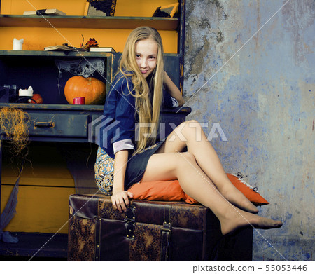 young pretty teenage girl in halloween holiday decorated interior happy smiling, lifestyle people young pretty teenage girl in halloween holiday decorated interior happy smiling, lifestyle people 55053446