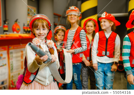 Child with hose in hands playing firefighter Child with hose in hands playing firefighter 55054316