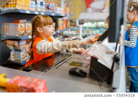Girl in uniform at the cash register, playroom Girl in uniform at the cash register, playroom 55054319