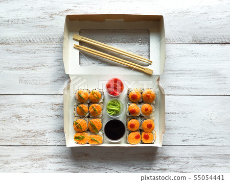 Sushi set in a box on a wooden table. Street food Sushi set in a box on a wooden table. Street food 55054441
