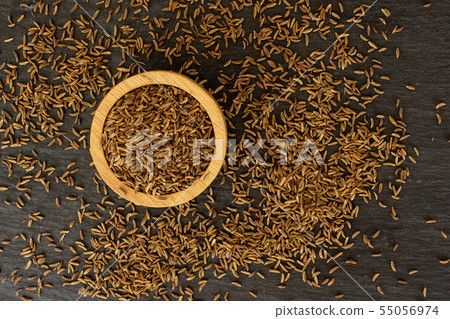 Dry caraway fruit on grey stone Dry caraway fruit on grey stone 55056974