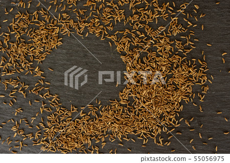 Dry caraway fruit on grey stone Dry caraway fruit on grey stone 55056975
