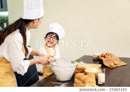 Happy asian family in the kitchen.Mother and son h Happy asian family in the kitchen.Mother and son h 55063165
