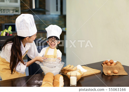 Happy asian family in the kitchen.Mother and son h Happy asian family in the kitchen.Mother and son h 55063166