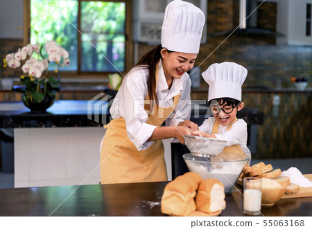 Happy asian family in the kitchen.Mother and son h 55063168