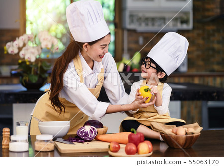 Happy asian family in the kitchen.Mother and son h Happy asian family in the kitchen.Mother and son h 55063170
