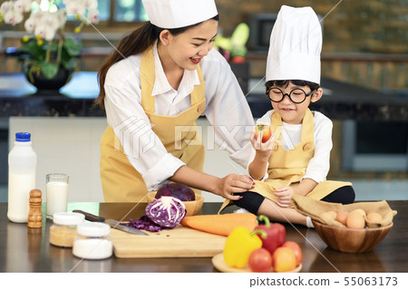 Happy asian family in the kitchen.Mother and son h Happy asian family in the kitchen.Mother and son h 55063173
