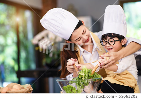 Happy asian family in the kitchen.Mother and son h 55063202