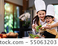 Happy asian family in the kitchen.Mother and son h 55063203