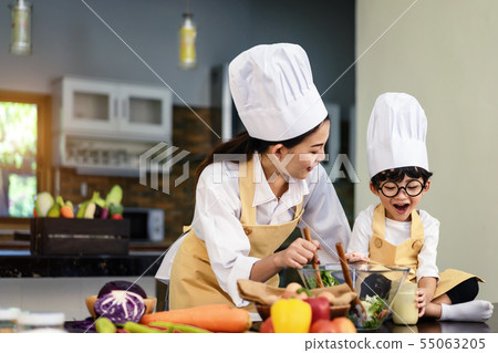 Happy asian family in the kitchen.Mother and son h Happy asian family in the kitchen.Mother and son h 55063205