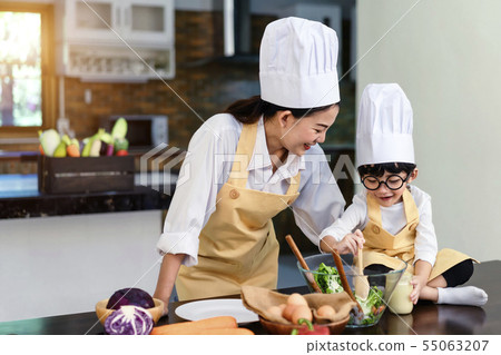 Happy asian family in the kitchen.Mother and son h Happy asian family in the kitchen.Mother and son h 55063207