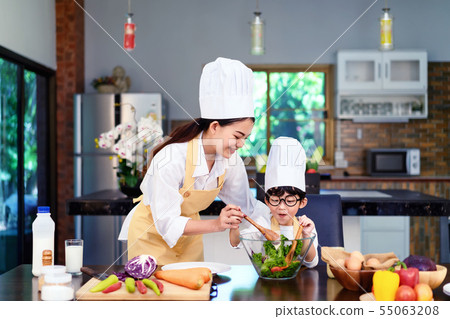 Happy asian family in the kitchen.Mother and son h 55063208