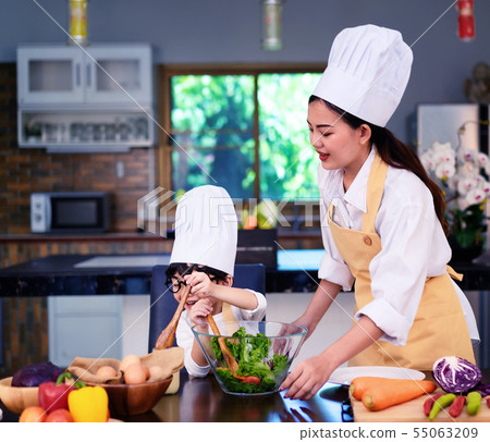 Happy asian family in the kitchen.Mother and son h 55063209