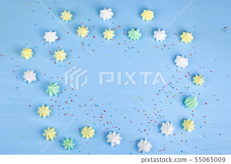 Meringue on a blue wooden background Meringue on a blue wooden background 55065009
