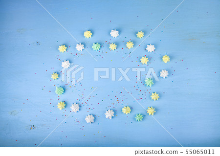 Meringue on a blue wooden background Meringue on a blue wooden background 55065011
