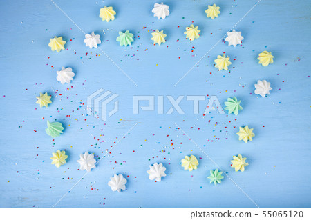 Meringue on a blue wooden background Meringue on a blue wooden background 55065120