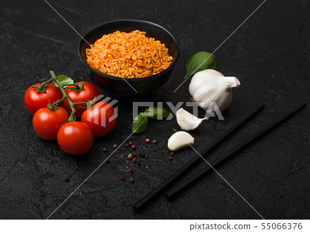Black plate bowl of rice with tomato and basil and Black plate bowl of rice with tomato and basil and 55066376