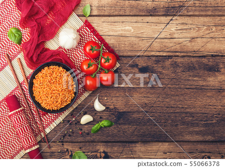 Black plate bowl of rice with tomato and basil and Black plate bowl of rice with tomato and basil and 55066378