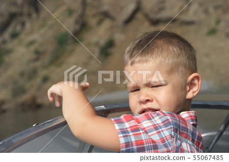 Little boy in a plaid shirt. In the summer on a yacht Little boy in a plaid shirt. In the summer on a yacht 55067485