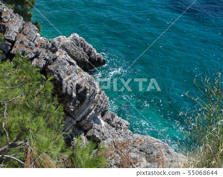 Rocky cliff and blue sea Rocky cliff and blue sea 55068644
