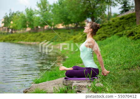 Young beautiful caucasian brunette girl doing yoga 55070412