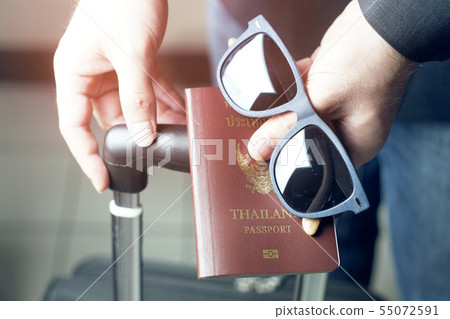 Businessman 's hand holding passport and 55072591