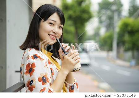 Woman drinking tapioca Woman drinking tapioca 55073149