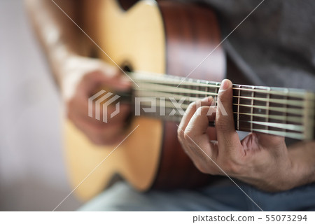 musician man playing acoustic guitar 55073294