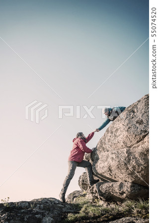 Two mans help each other hiking Two mans help each other hiking 55074520