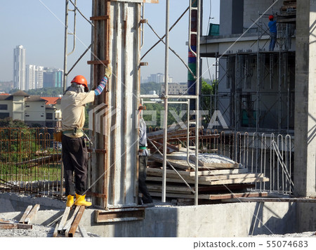 Workers installing & fabricating timber form work Workers installing & fabricating timber form work 55074683