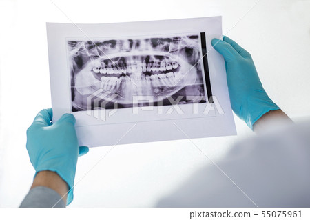 Image of male doctor or dentist holding and Image of male doctor or dentist holding and 55075961
