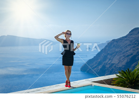 Beautiful woman in dress against the sea Beautiful woman in dress against the sea 55076212
