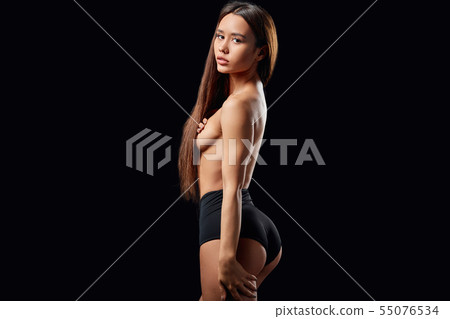 shirtless woman with palms on her breasts looking back shirtless woman with palms on her breasts looking back 55076534