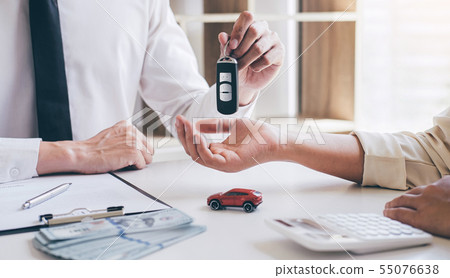 Car rent agent manager holding key of new car Car rent agent manager holding key of new car 55076638