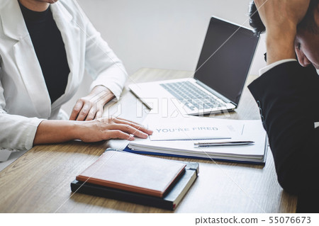 Stressed businessman receive fired letter from Stressed businessman receive fired letter from 55076673
