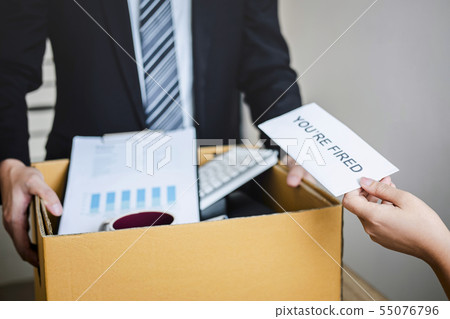 Stressed businessman receive fired letter from Stressed businessman receive fired letter from 55076796