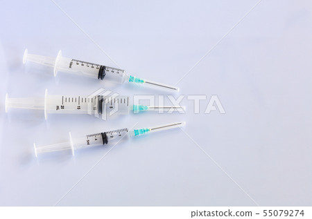 Several different syringes on a white smooth table Several different syringes on a white smooth table 55079274