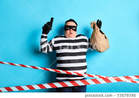 fat burger with raised arms holding a sack with money and pistol 55079398