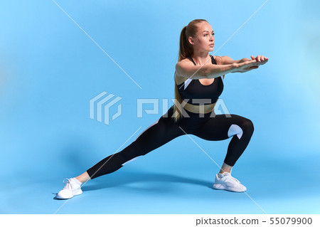 fair-haired slim girl doing exercises to be healthy. 55079900