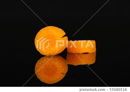 Peeled baby carrot isolated on black glass 55080516