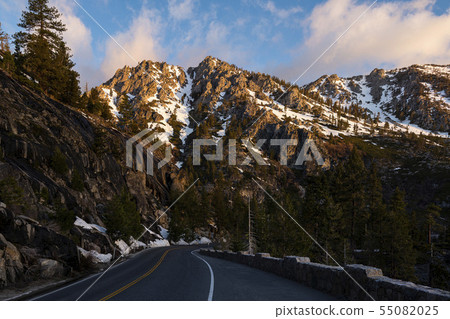 Countryside road leads to snowy mountains Countryside road leads to snowy mountains 55082025