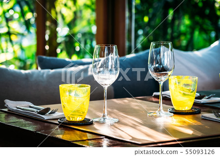 Wine glass with dining set prepare for breakfast lunch or dinner on table in restaurant Wine glass with dining set prepare for breakfast lunch or dinner on table in restaurant 55093126