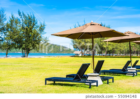 Umbrella and chair on the green grass nearly sea beach 55094148