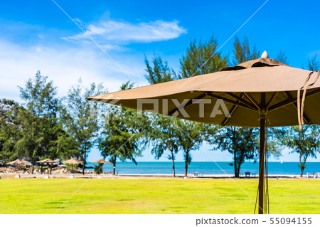 Umbrella and chair on the green grass nearly sea beach 55094155