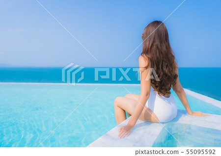 Portrait beautiful young asian woman happy smile relax in swimming pool for travel vacation 55095592