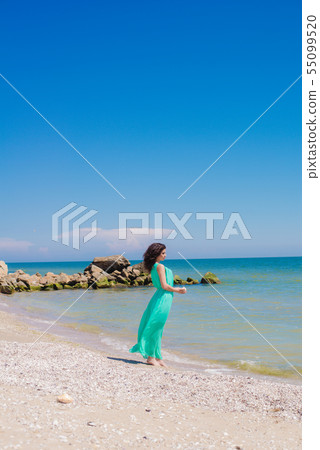 Young girl on summer beach with shell Young girl on summer beach with shell 55099520
