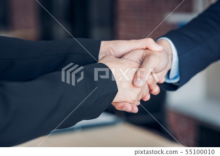 Close up two handshake between businesswoman and Close up two handshake between businesswoman and 55100010