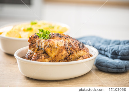 Whole chicken roasted in a porcelain bowl with Whole chicken roasted in a porcelain bowl with 55103068