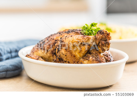 Whole chicken roasted in a porcelain bowl with 55103069