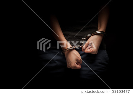 woman with handcuff on a dark background  55103477